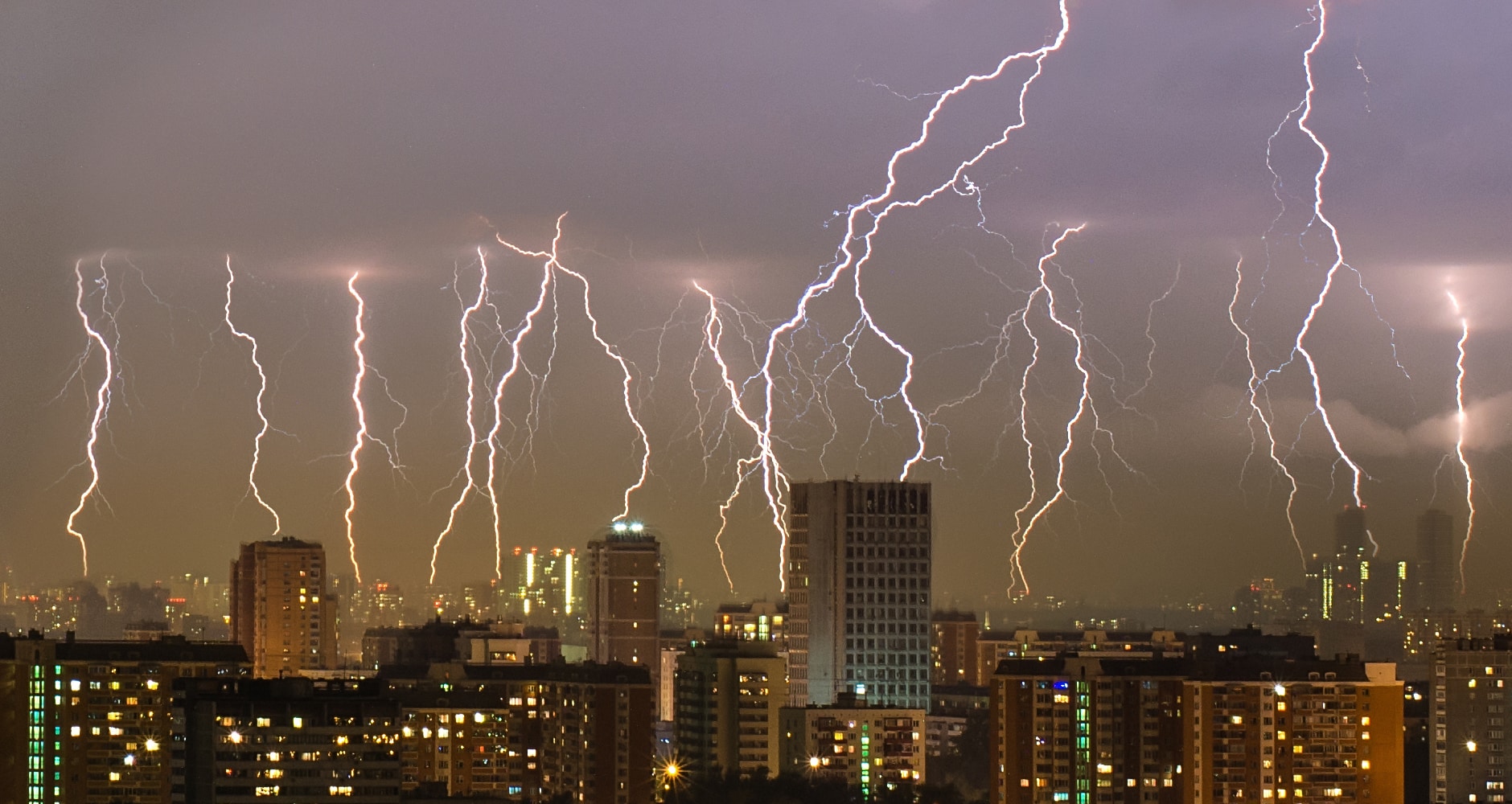 lightning strikes over a cityscape