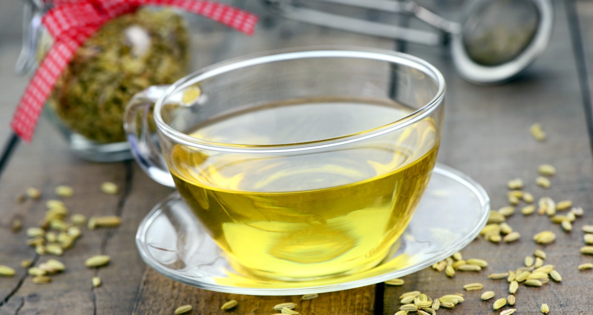 A fennel tea in a glass cup and plate.