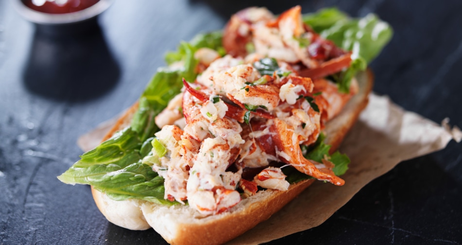 A lobster salad sandwich with lettuce.