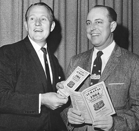 Ark Linkletter holding copies of the Farmers' Almanac with Ray Geiger.