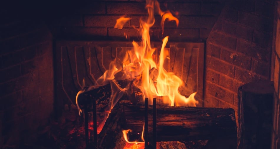 Yule logs burning in a fireplace.