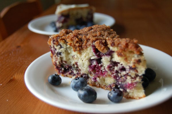 slice of blueberry buckle cake on white plate