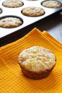 close-up muffin with curd, carrots and oat flakes on orange placemat