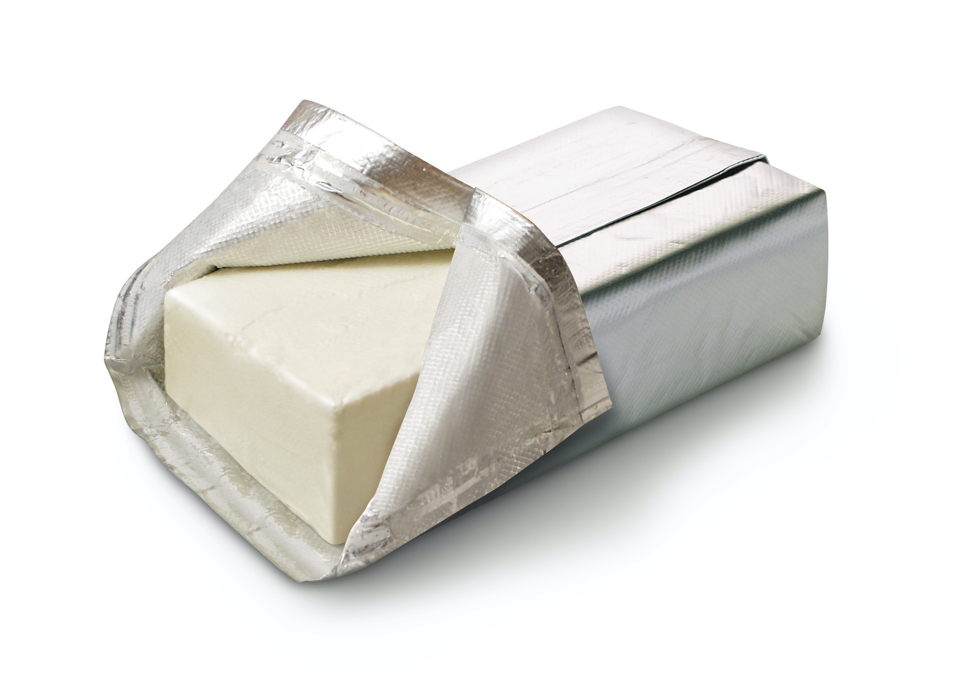 brick of cream cheese on white background