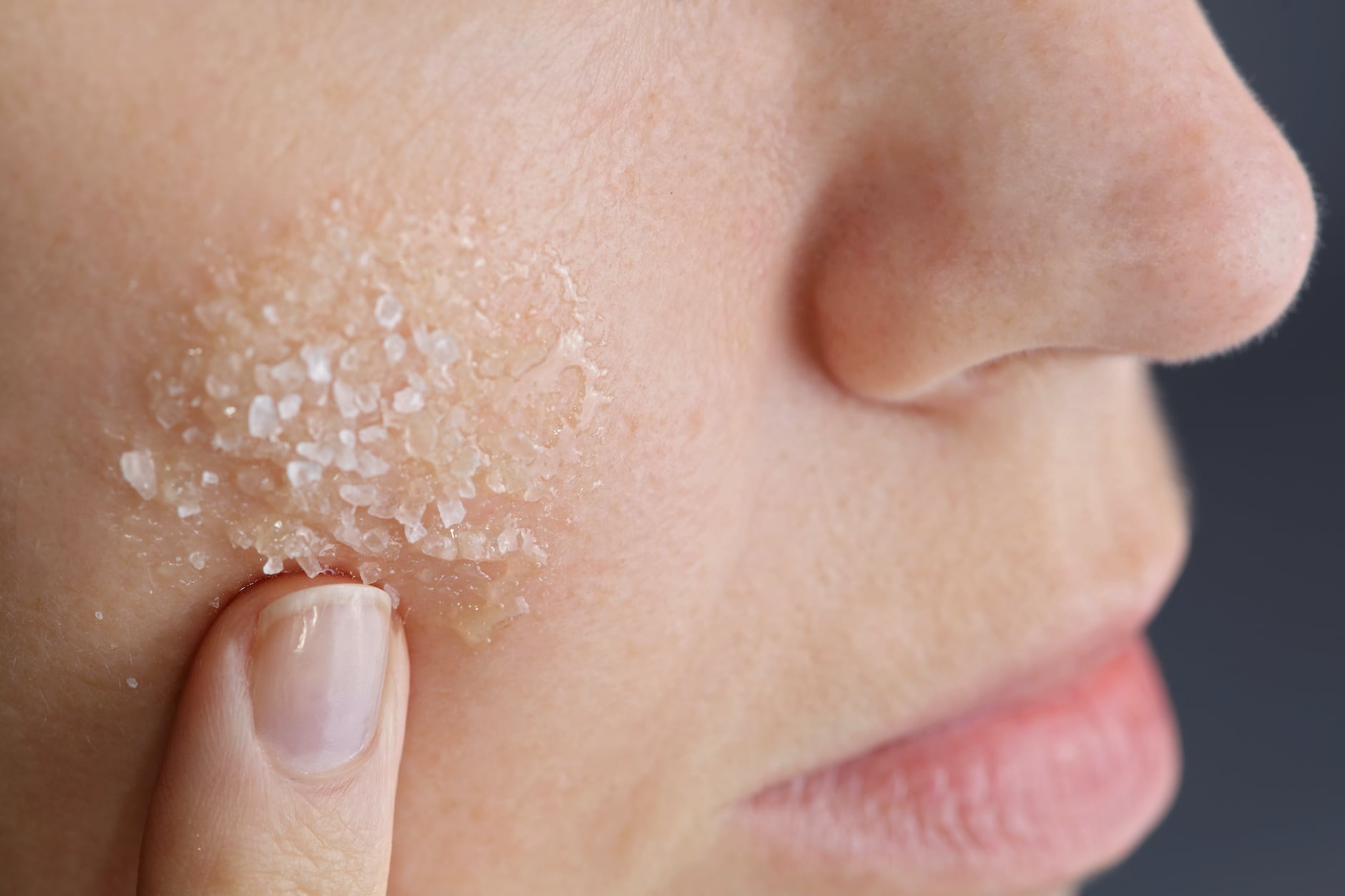 A small bowl of exfoliating scrub on a bathroom counter.