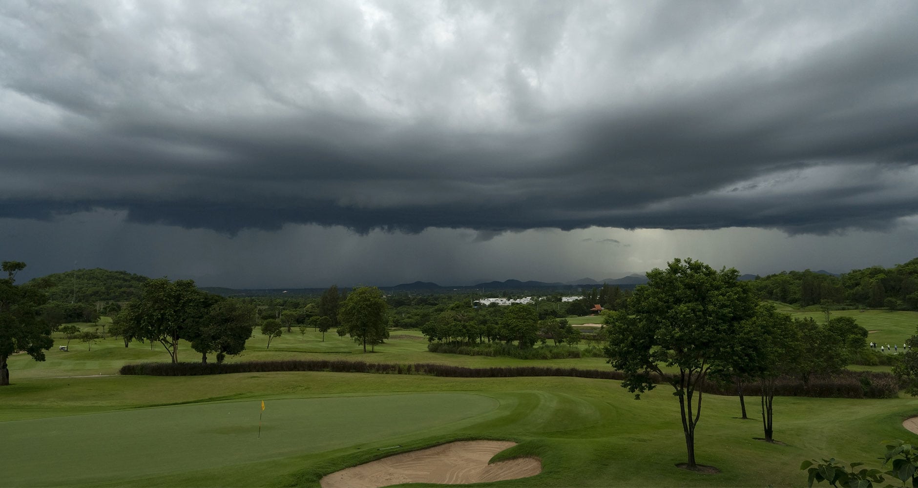 golf course with dark clouds for lightning safety