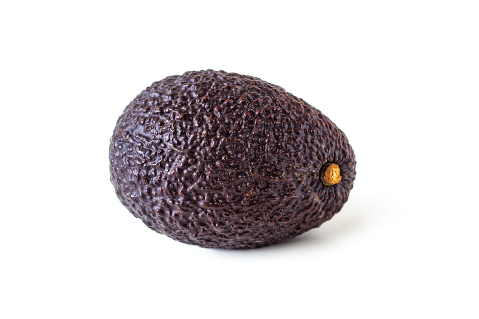 A purple hass avocado against a white background.