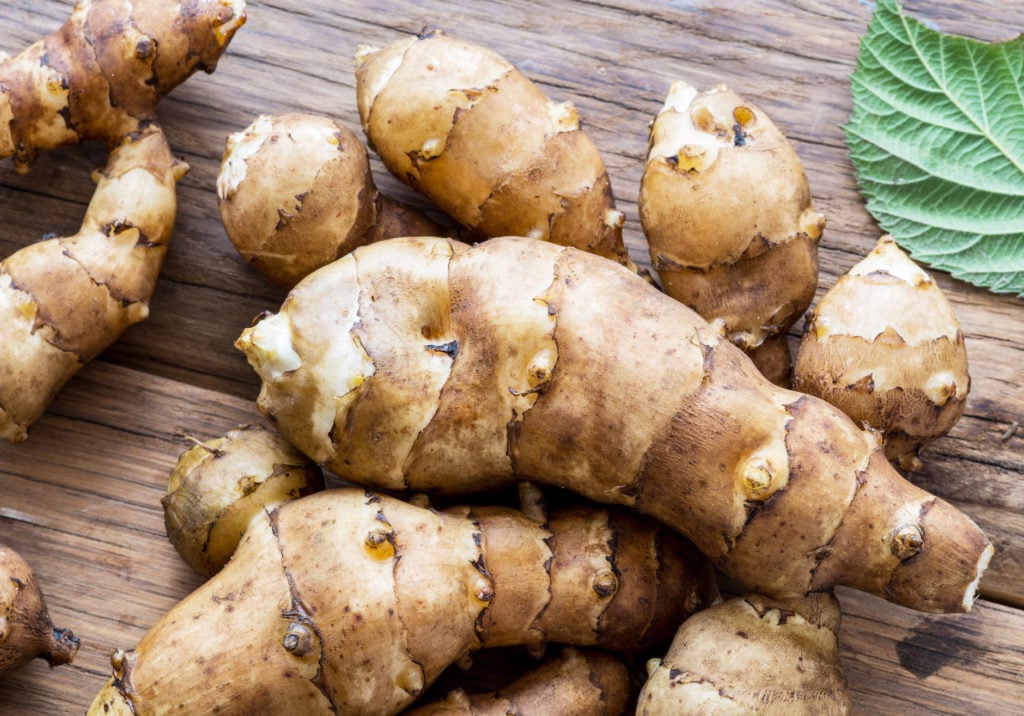 Jerusalem artichoke on wooden background