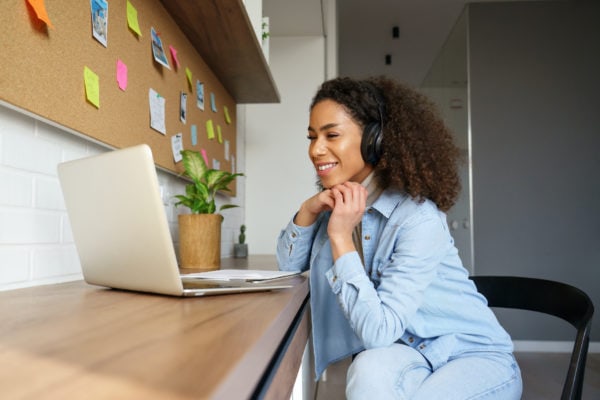 woman watching slideshow on computer smiling