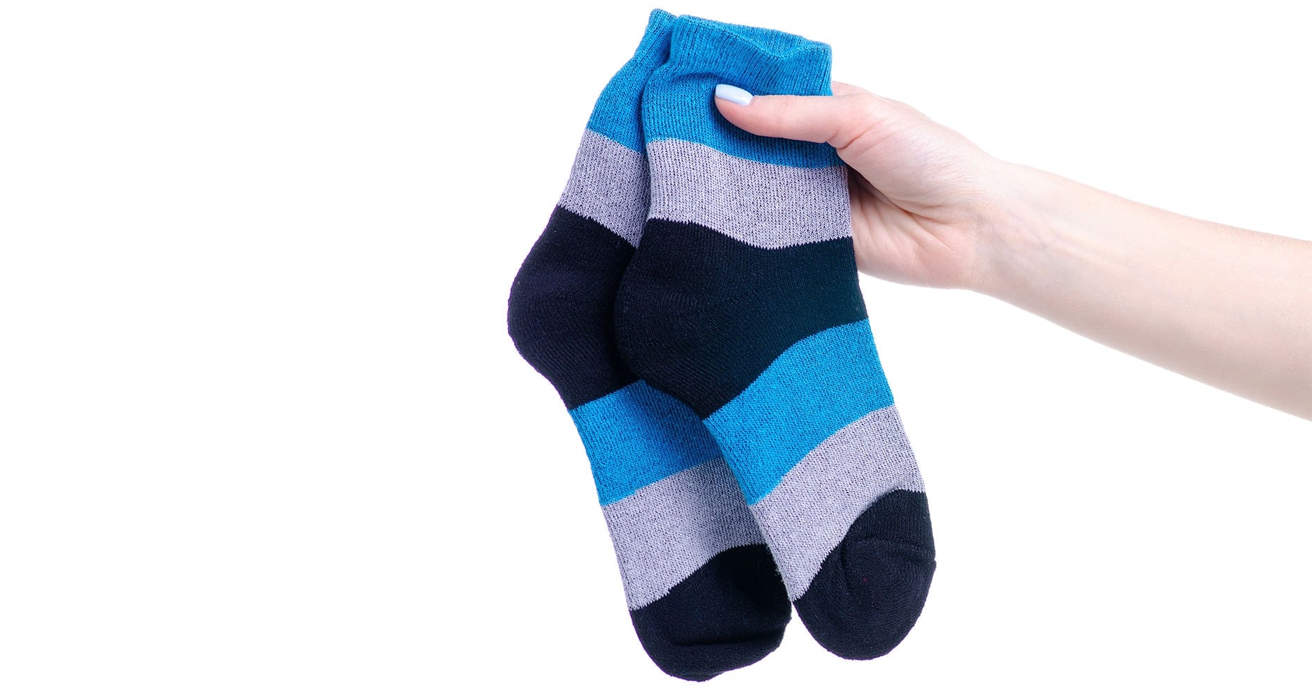 A pair of warm winter socks folded on a wooden surface, ready to keep feet dry during snow shoveling.