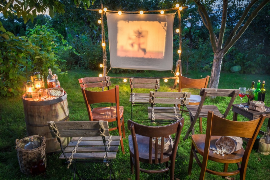 Summer cinema with retro projector in the garden.