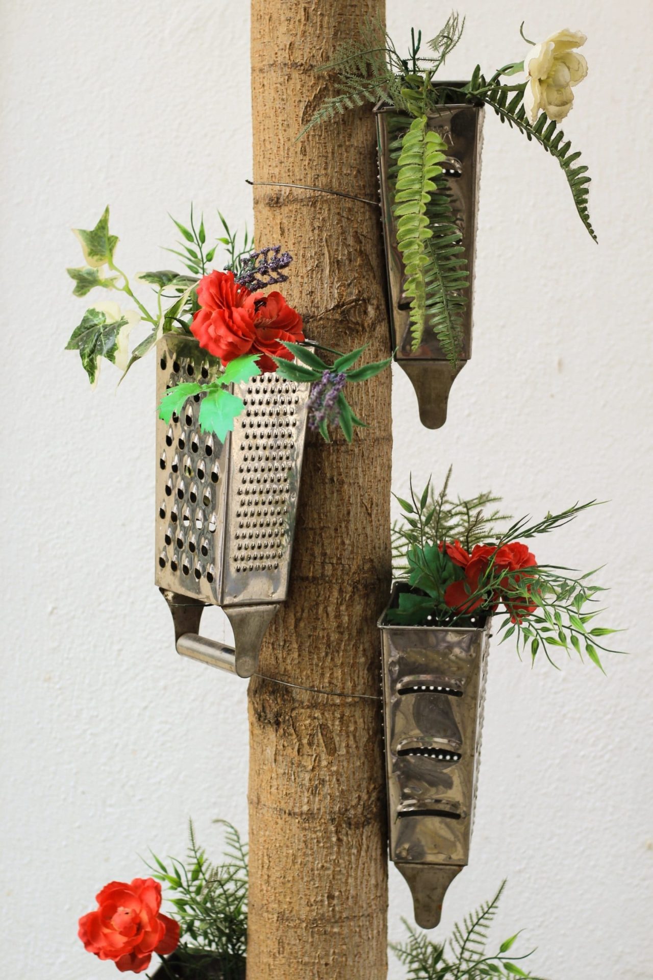 An old cheese grater repurposed as an earring hanger.