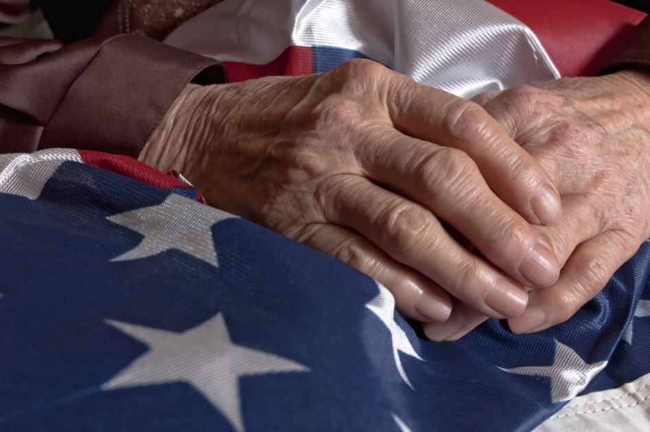 Hands holding an American flag.