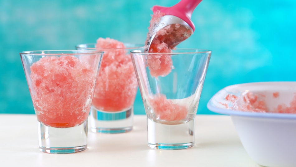 Watermelon granita desserts on a blue and white background.