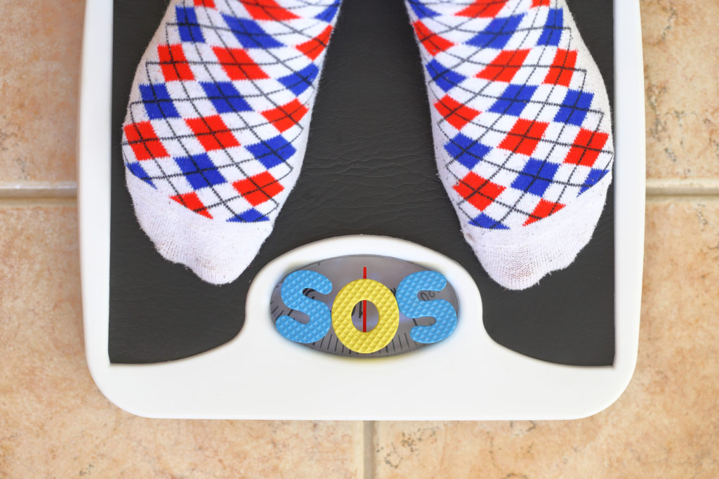 Woman's feet on bathroom scale. Diet concept