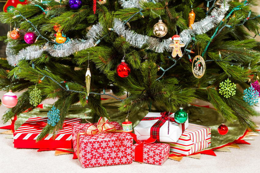 Christmas presents wrapped in colorful paper under a Christmas Tree.