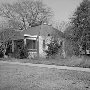 Black and white photo of a cottage or small house.