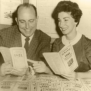 Vintage photo of Ray and Ann Geiger holding copies of the Farmers' Almanac.
