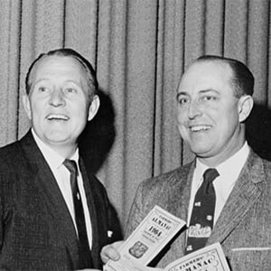 Art Linkletter with Ray Geiger holding up copies of Farmers' Almanac.