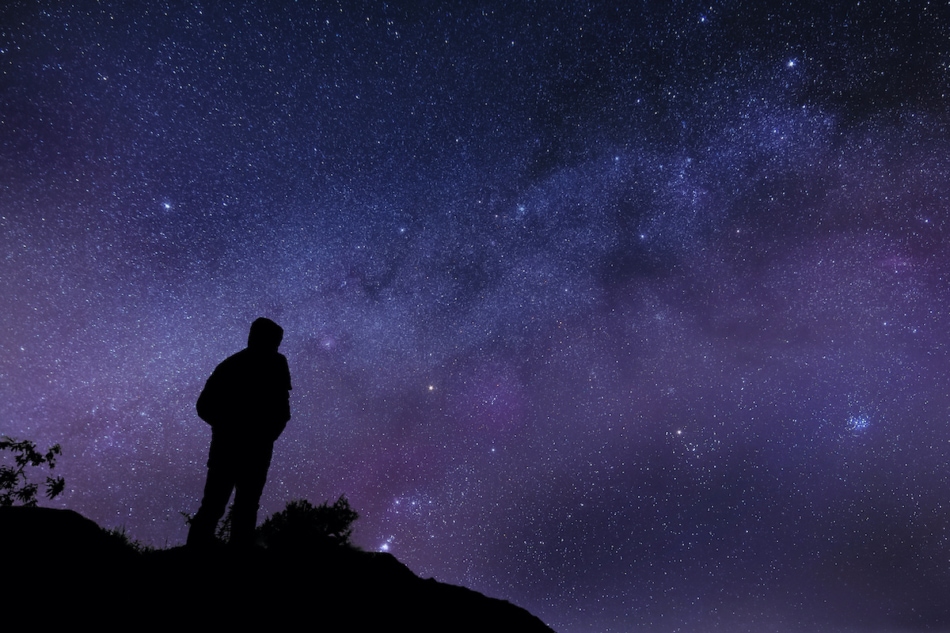 Silhouette of a man watching the Milky way and the Stars