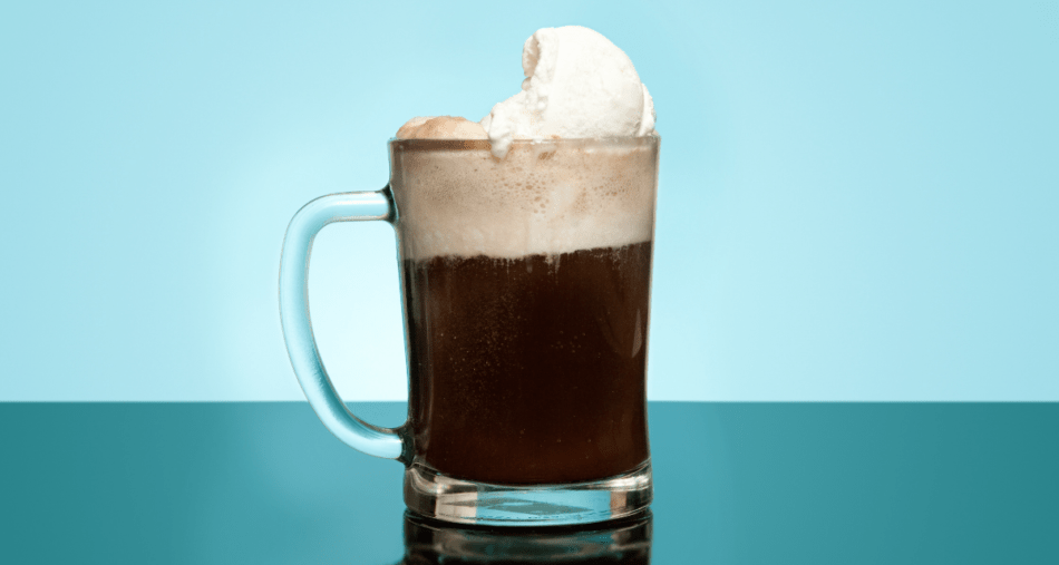 Root beer in a frosty mug on blue background