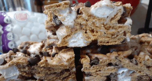Close up of smores crispy cereal bars with chocolate chips and marshmallows.