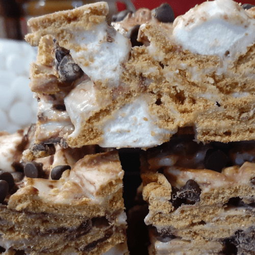 Close up of smores crispy cereal bars with chocolate chips and marshmallows.