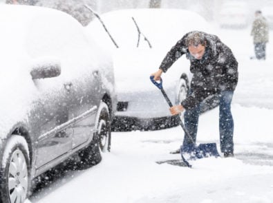 A man shoveling snow during Canadian winter 2020-2021.