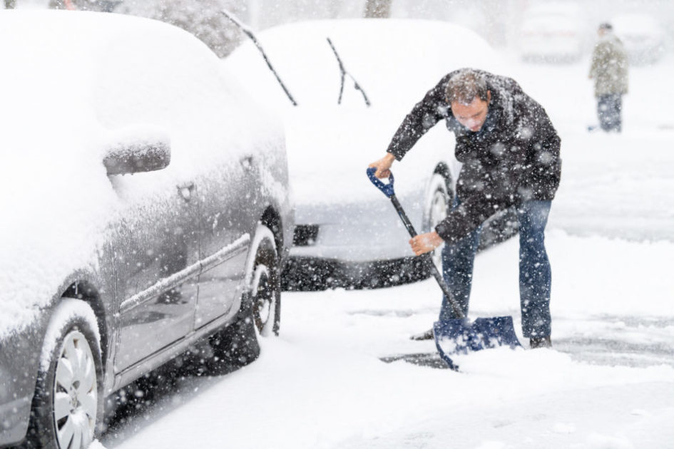 A man shoveling snow during Canadian winter 2020-2021.