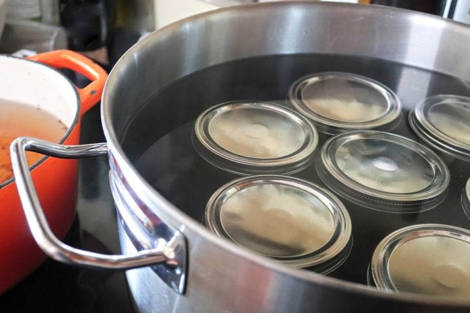 Pickling jars in a pot full of water.