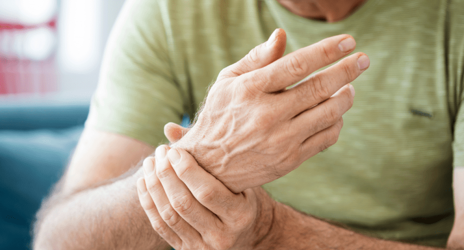 Man rubbing his sore wrist.