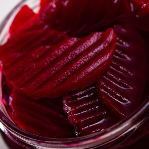 Glass jar of homemade pickled beetroot on table, natural probiotic