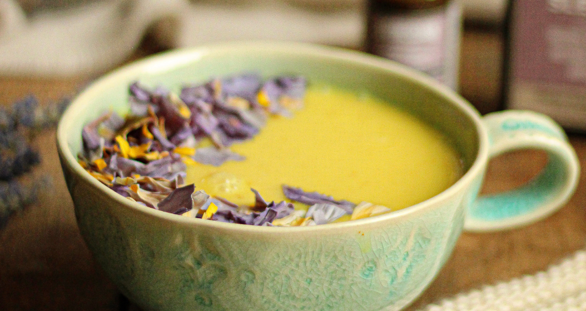 Golden moon milk with turmeric in a small cup