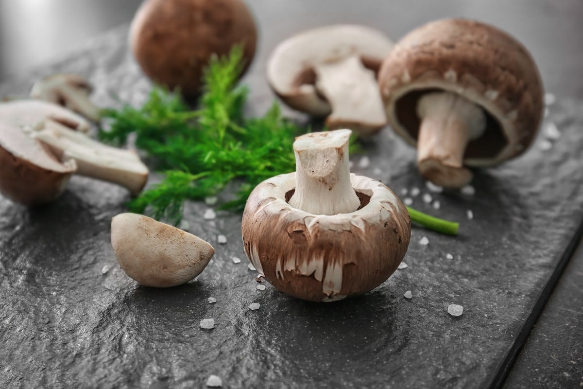 Cremini mushrooms on a slate plate