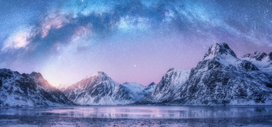 Snow covered mountains with starry sky.