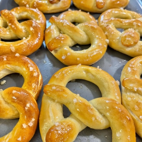 Soft pretzels on baking tray.