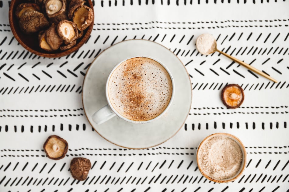 Top view of mushroom latte with shiitake powder and vegetarian blend milk. Healthy useful vegan drink, flat lay.