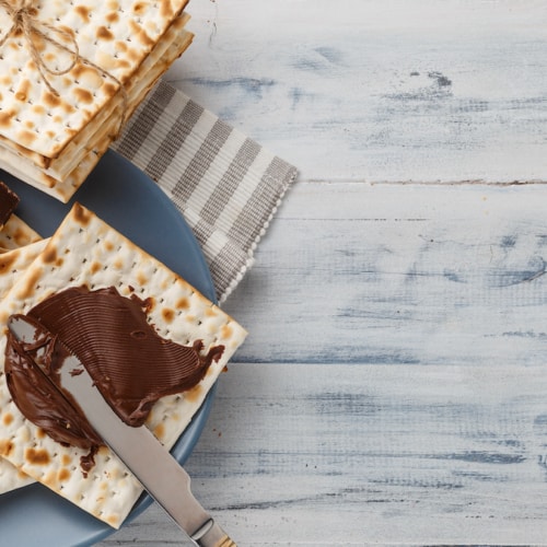 Matzah bread with chocolate cream and knife.