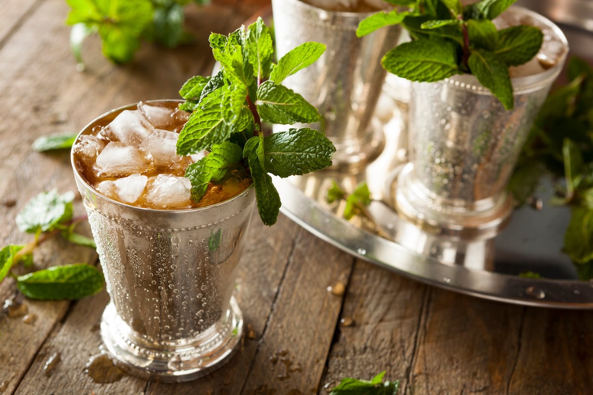 Classic mint julep cocktail in a silver cup with crushed ice and a sprig of fresh mint