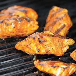 Recipe - Small fillets of fish cooking on a grill.