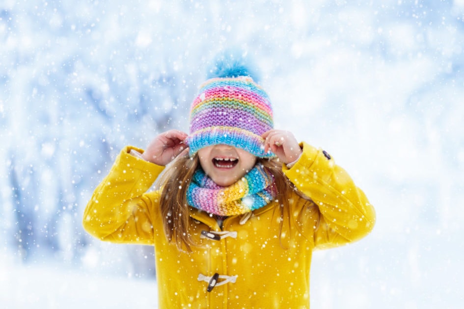 A girl in a yellow jacket enjoying Canadian weather 2021-2022.