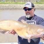 Well known catfishing writer Brad Durick holding a catfish.