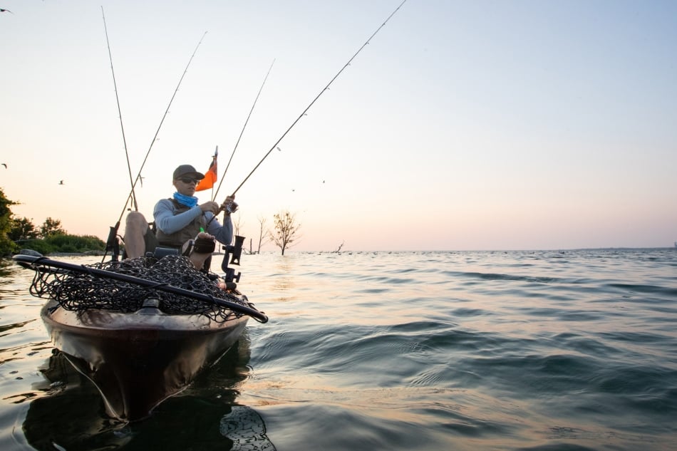 A kayak fisherman fishing.