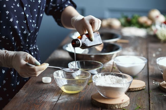 A woman showing how to make soap.