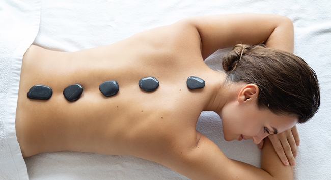 Heat therapy using hot stones.