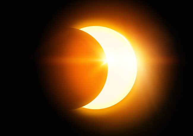 A solar eclipse with the Moon passing the Sun in the sky.