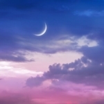 a new Moon in a twilight sky.