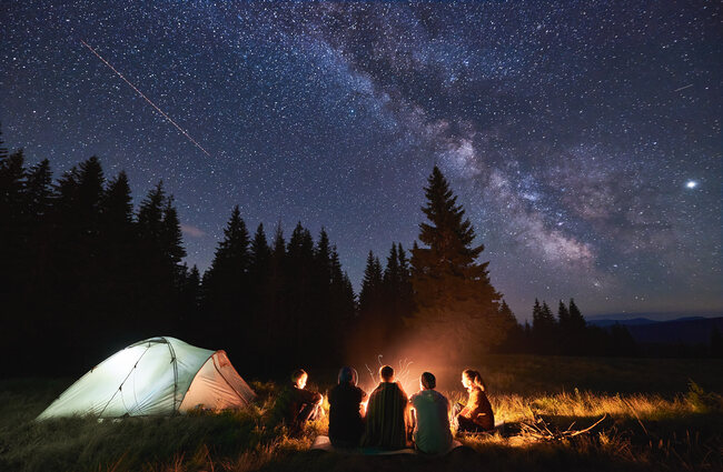 Family camping under stars.