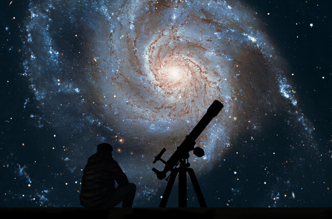 Pinwheel supernova and man with a telescope.