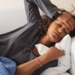 Woman with a fever to symbolize feed a cold starve a fever.